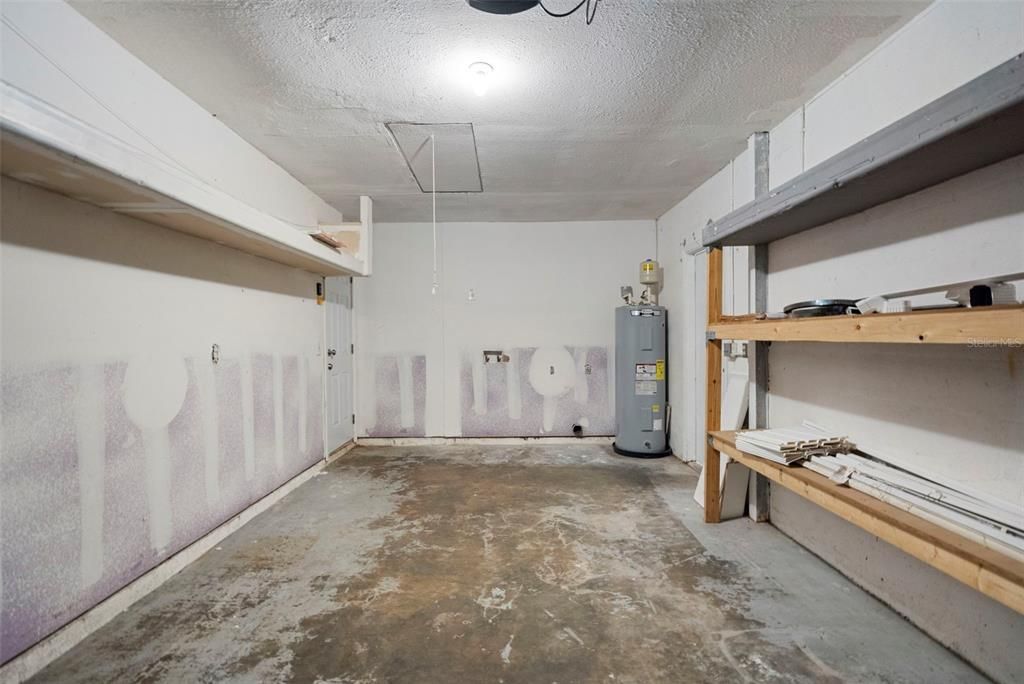 Garage with laundry area and shelving for storage!