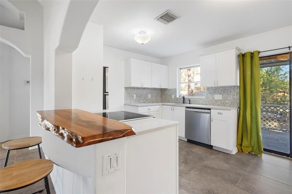 Kitchen with bar top seating.