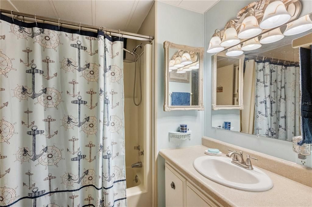 Guest bathroom has tub/shower combo.