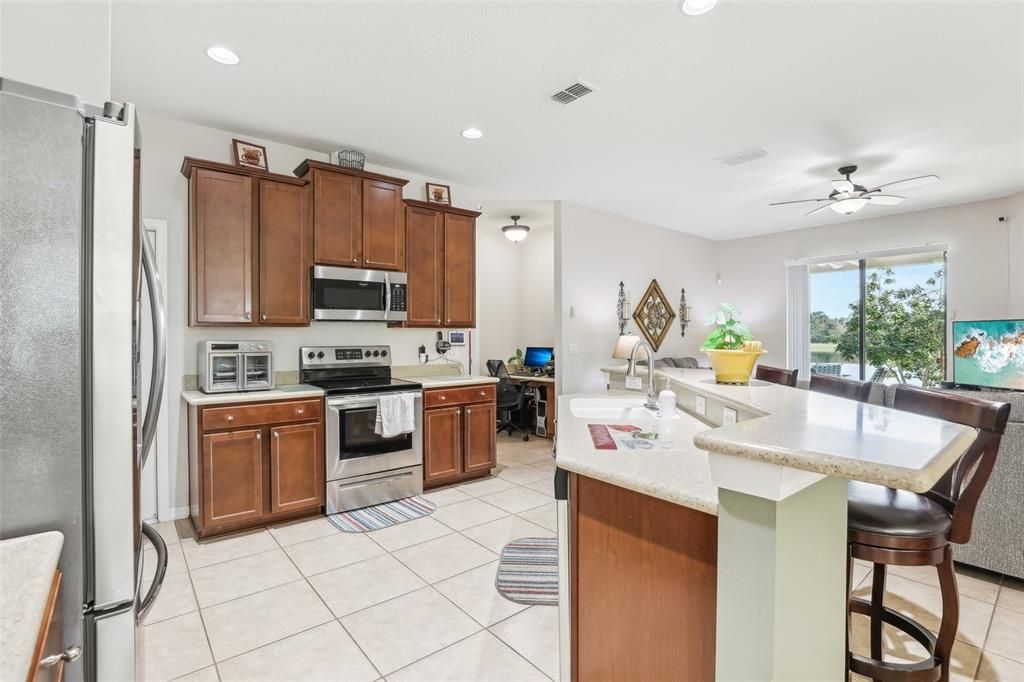 The Oversized Kitchen has the perfect amount of counter and cabinet space, a LARGE BAR, STAINLESS STEEL APPLIANCES and a BEAUTIFUL shade of CORIAN Countertops!! The entire kitchen overlooks and opens up to the Main Living Area (Family Room)