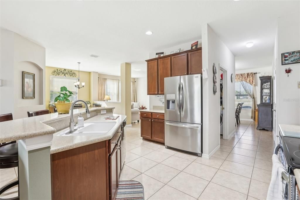 The Oversized Kitchen has the perfect amount of counter and cabinet space, a LARGE BAR, STAINLESS STEEL APPLIANCES and a BEAUTIFUL shade of CORIAN Countertops!! The entire kitchen overlooks and opens up to the Main Living Area (Family Room)