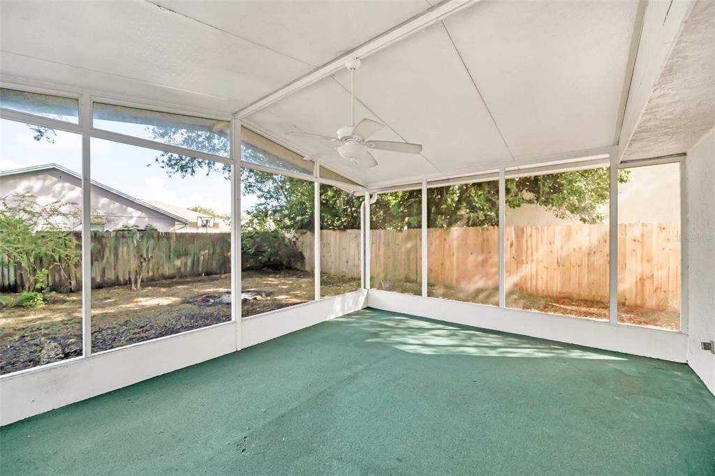 Family Room with sliding glass door access to huge covered and screened back patio