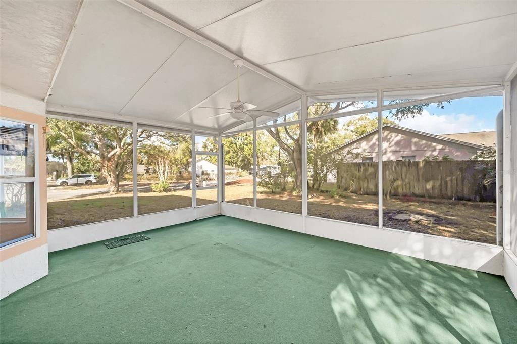 sliding glass door access to huge covered and screened back patio