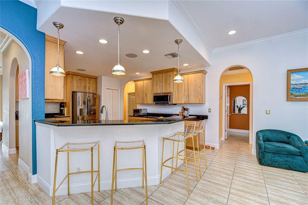 Kitchen features large bar with seating.