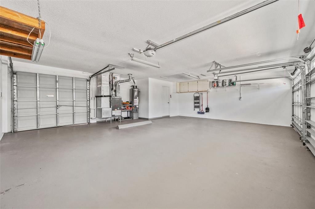 3rd garage door to left opens to back yard and separate patio / lanai. Door in upper middle leads to spacious inside laundry off the kitchen.