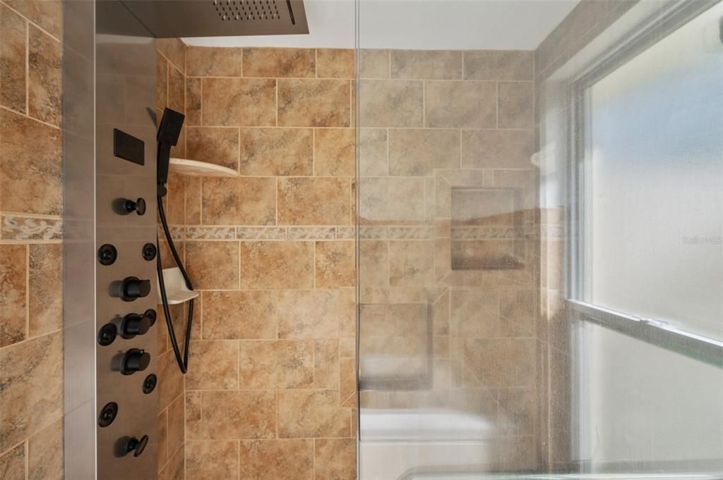 Master bedroom shower with digital controls and rain shower.