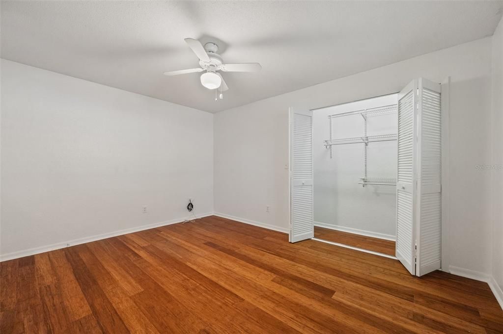 Bedroom #2 with bamboo flooring & lighted closet.