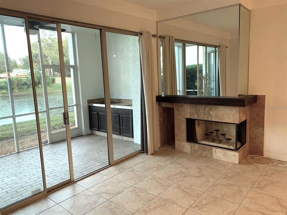 Fireplace in greatroom with mirror above.