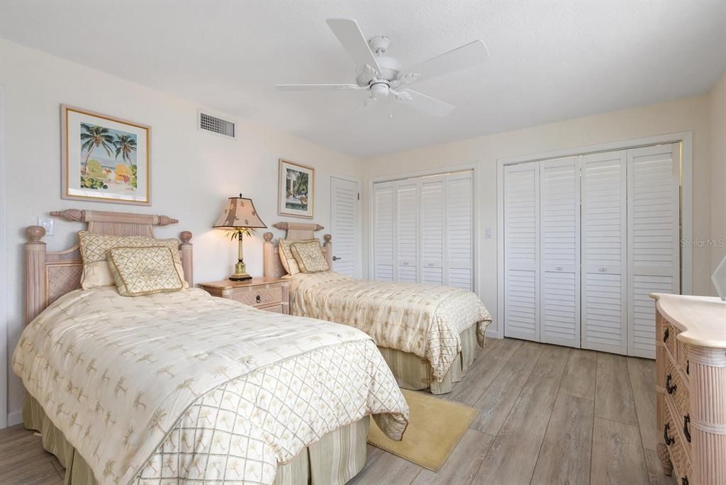 Second bedroom with wall of closets and utility/storage closet