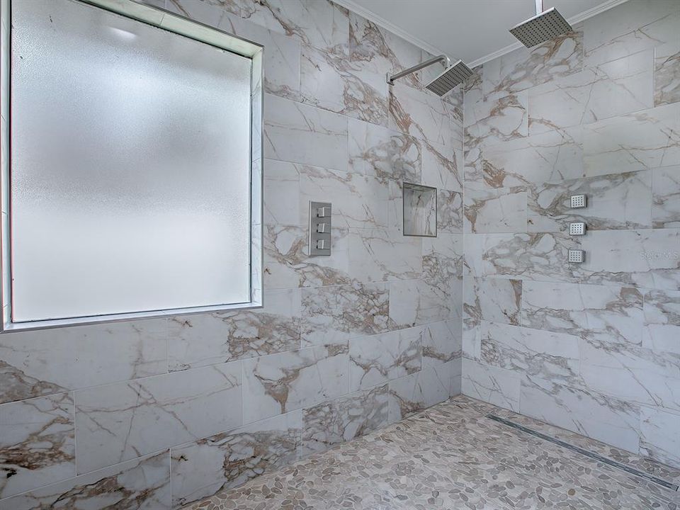 Primary bath area with rain shower & dueling wall jets