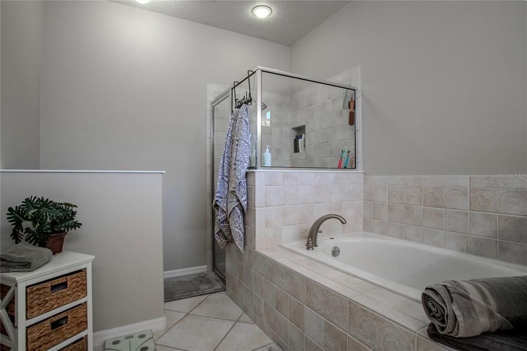 Primary Bath with private commode area, walk-in shower and jetted tub.