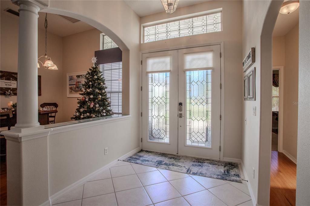 Grand Foyer with double leaded glass entry doors and transom windows