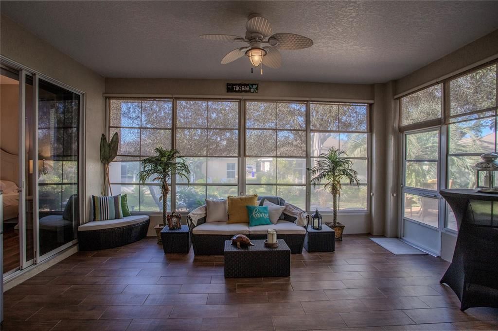 Lanai with wood-look ceramic tile and vinyl windows and screens.