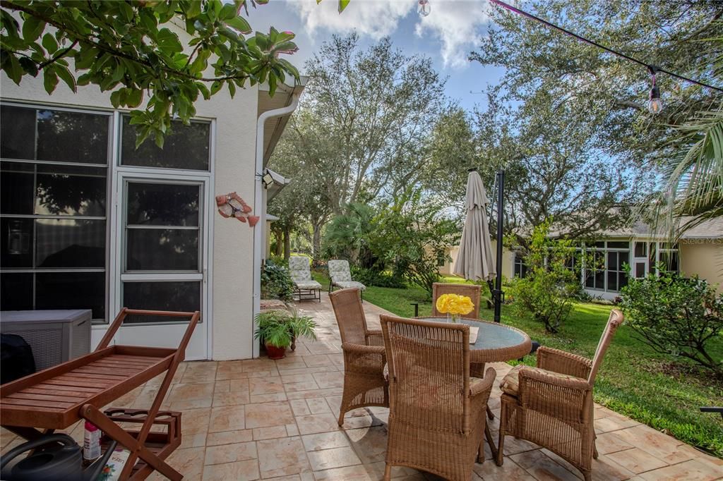 Back patio. Enjoy the mature landscaping and wonderful fruit trees!