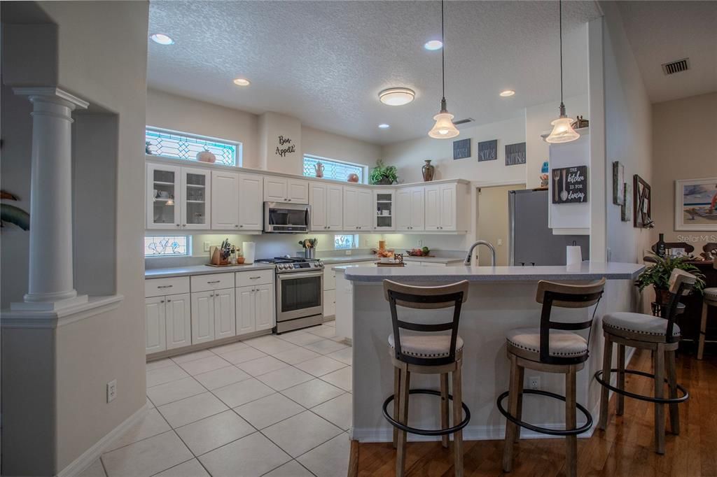 Fabulous Dream Kitchen with center island, abundant cabinets and Corian counters, and upgraded stainless steel appliances.