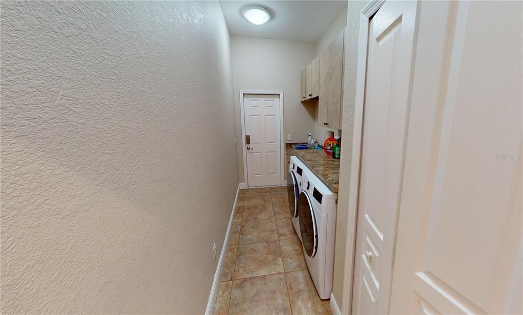 Laundry room with outside access door