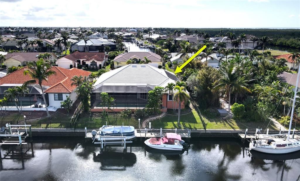 Rear aerial view of home and canal