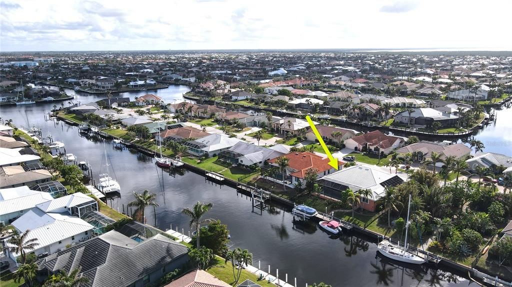 Rear aerial view of home and canal