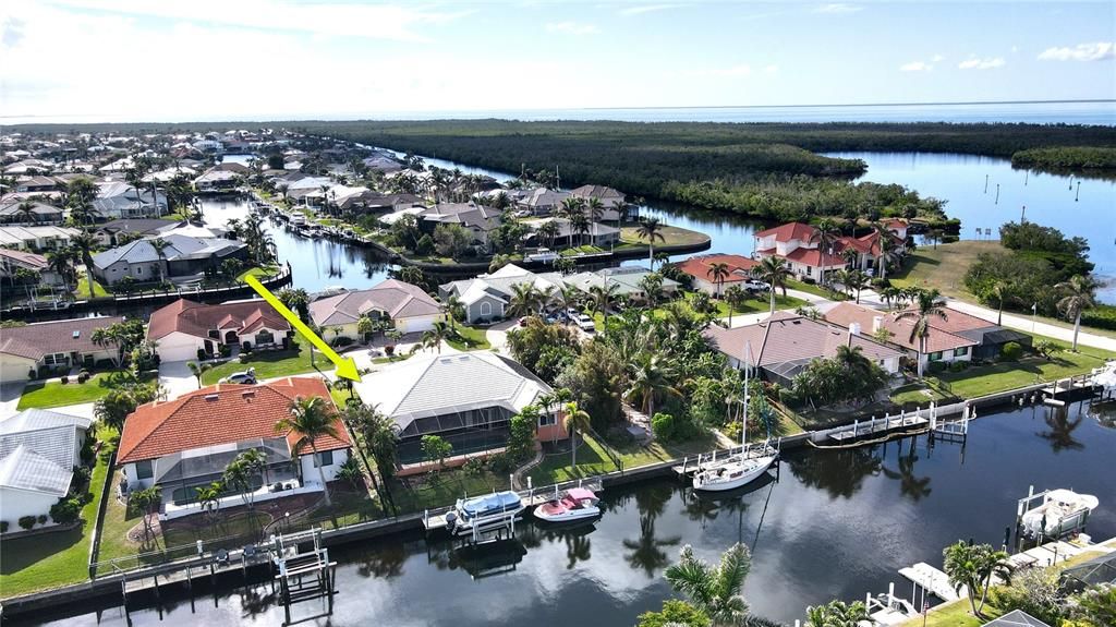 Rear aerial view of home and canal