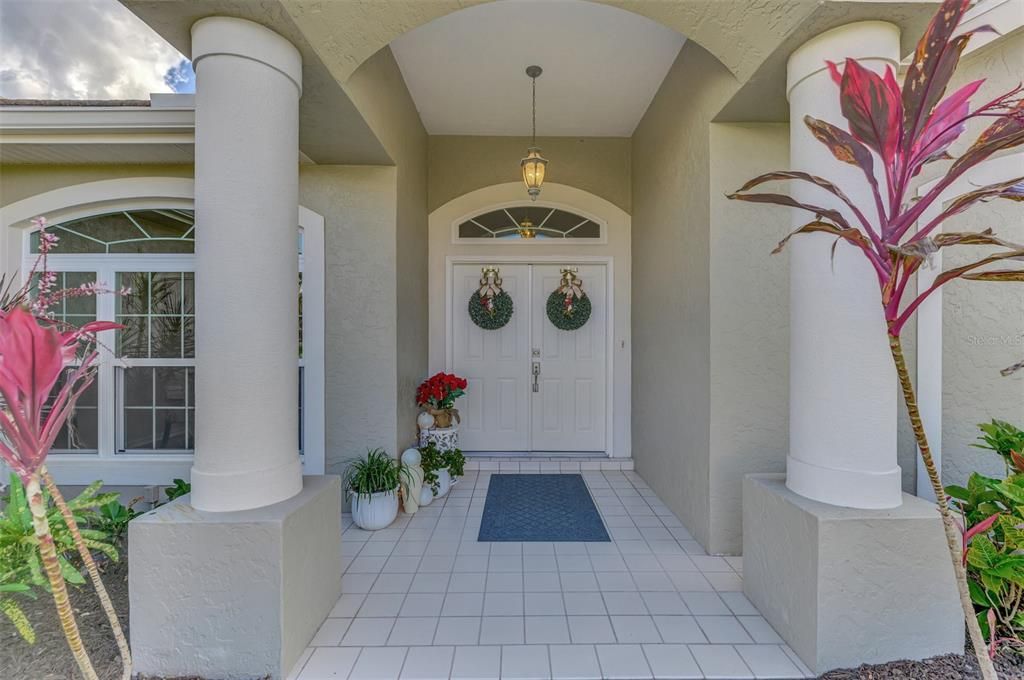 Welcoming entry with hurricane doors