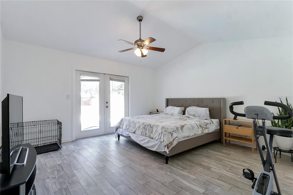 Primary suite with entrance to pool and backyard