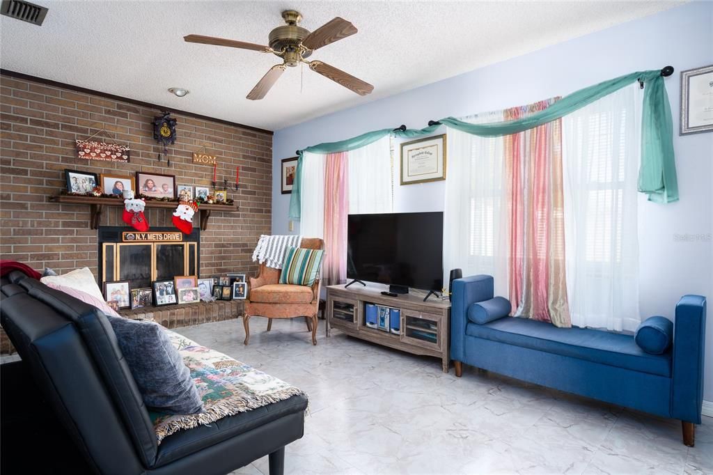 Rear family room includes plenty of natural lighting and fireplace.