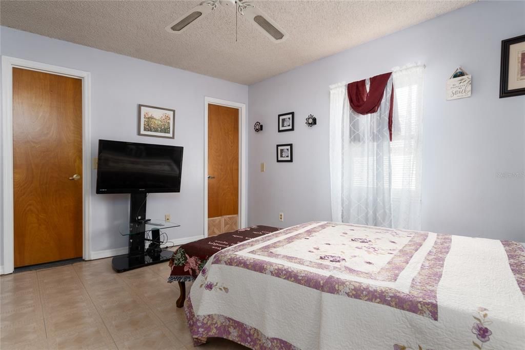 Primary Suite towards walk-in closet (left) and ensuite bath (right).