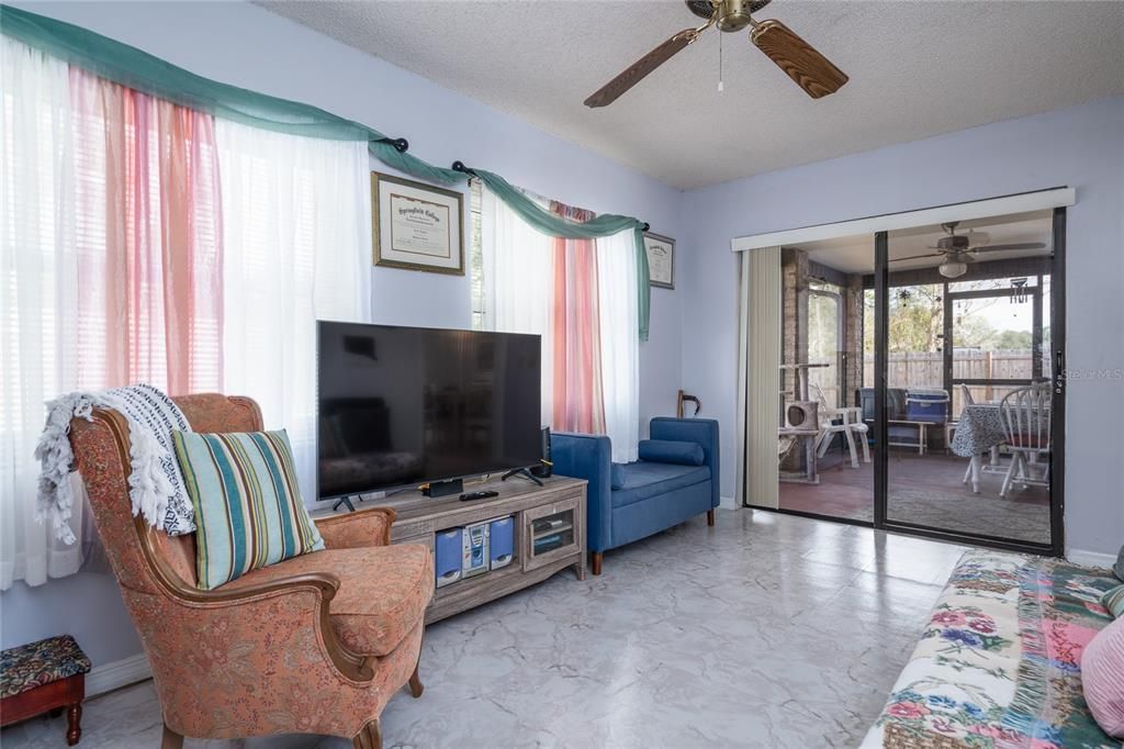 Rear family room towards private screened patio.