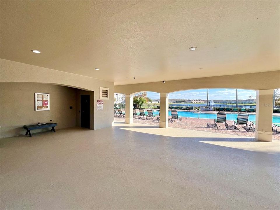 Covered lanai and bathrooms in pool area