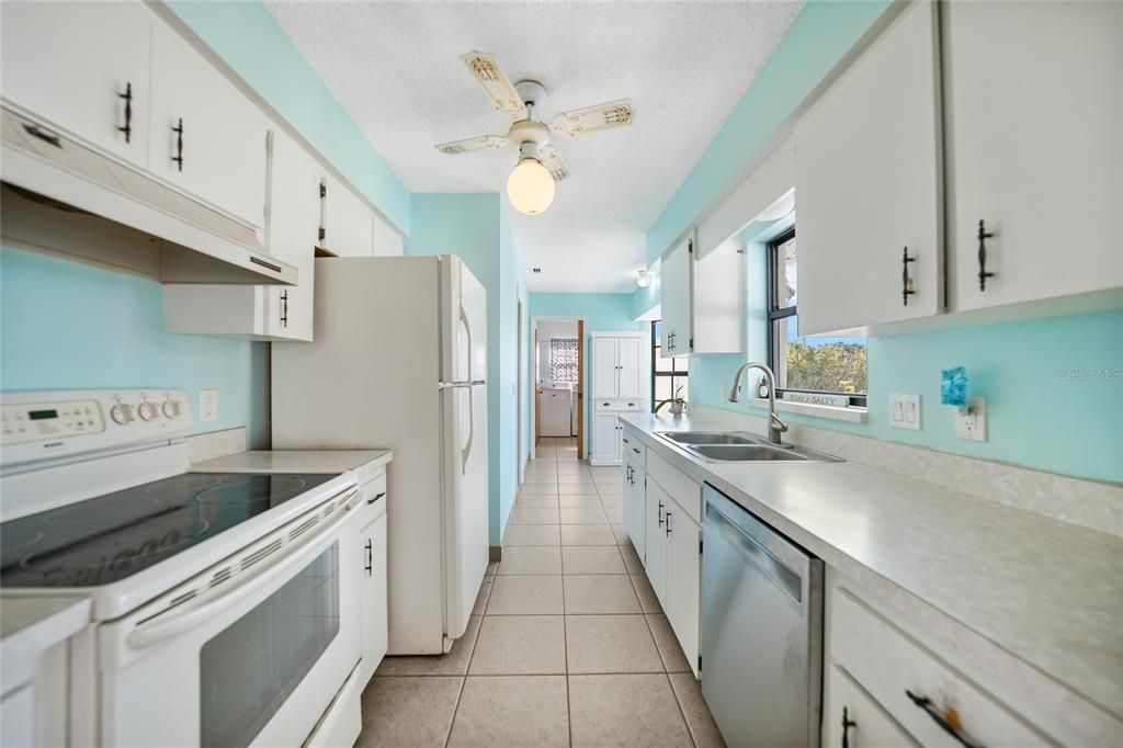 Kitchen provides great counter space & window looking out over lanai and pool