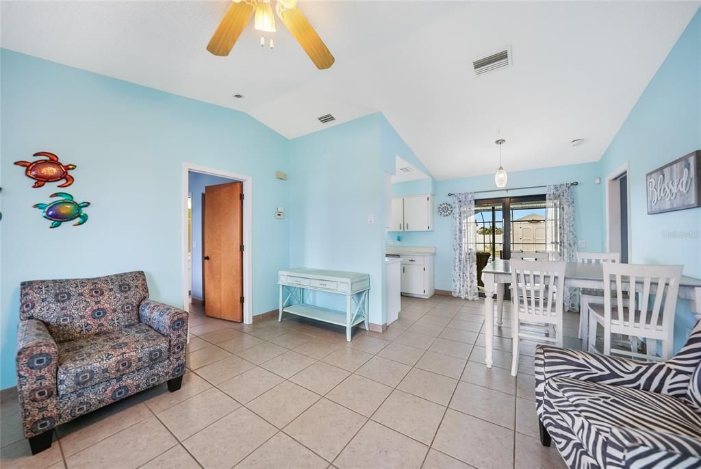 Living room. Door on left goes to 2nd bedroom. Sliding doors go to pool and lanai.