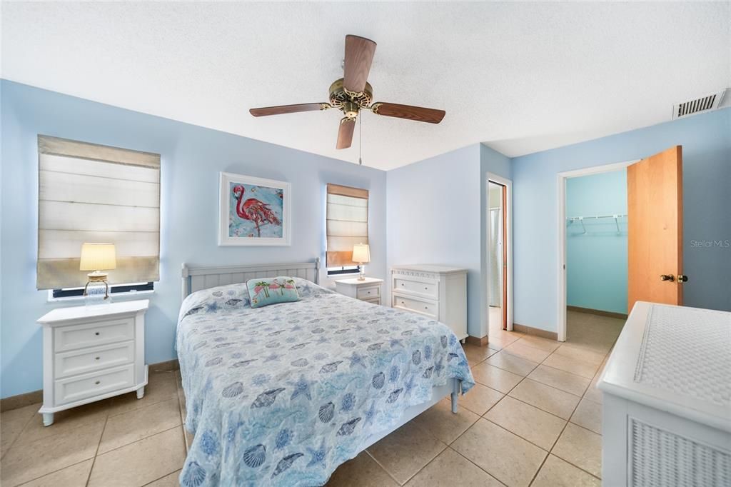 Primary bedroom with walk in closet. Pocket door to bathroom also pictured here