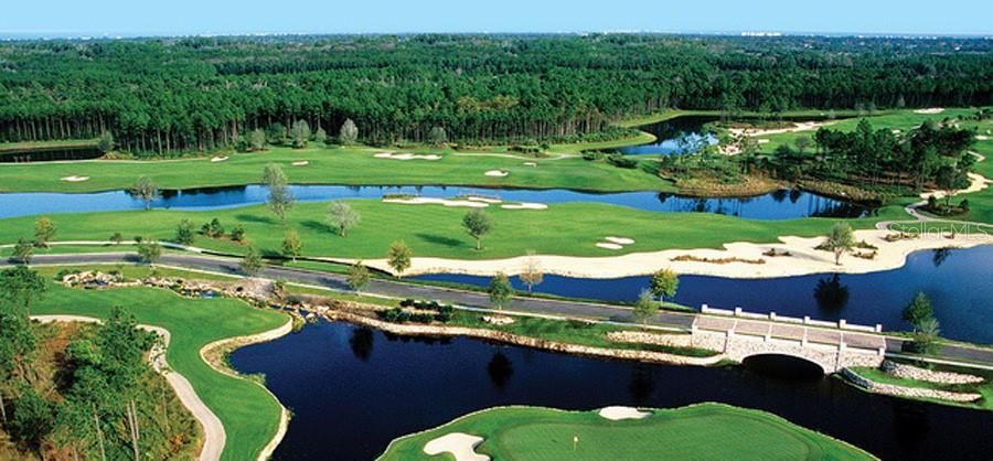 Aerial view from 8th to Conservatory drive with stone bridge and golf course holes on right side of bridge.