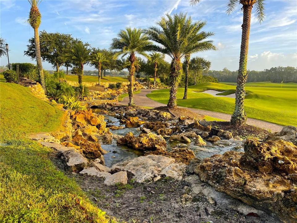 Waterfall cascading next to golf course