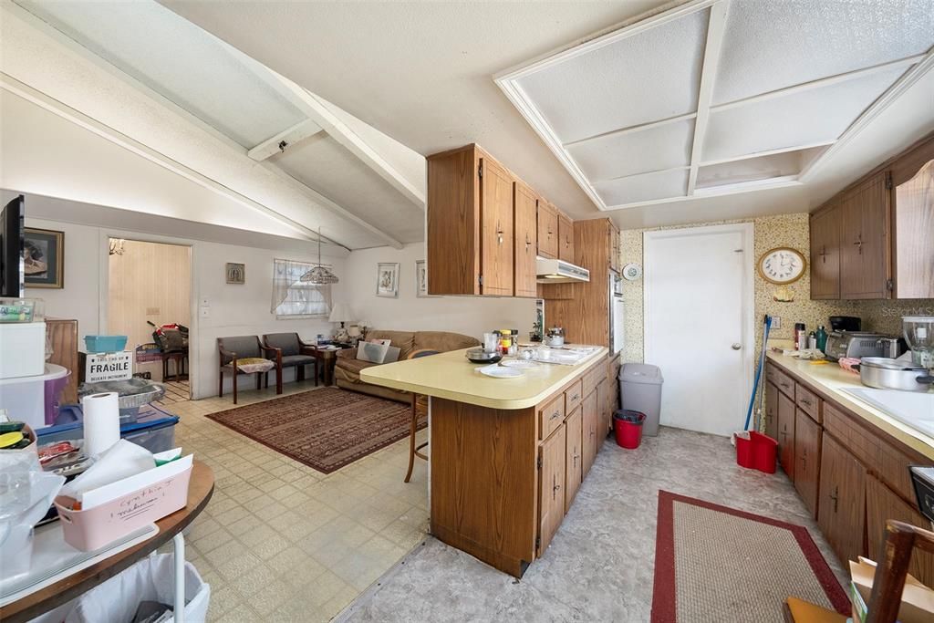 Remove ceiling cabinets for an open sightline to the second living room.