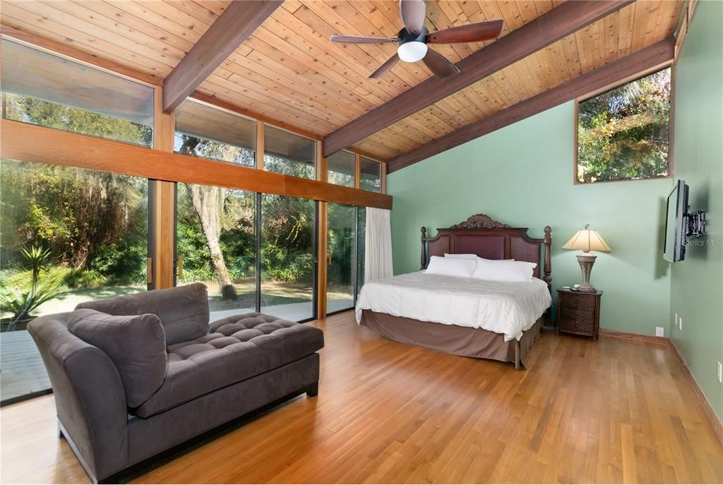 Master Bedroom with wall of glass offering views of outside