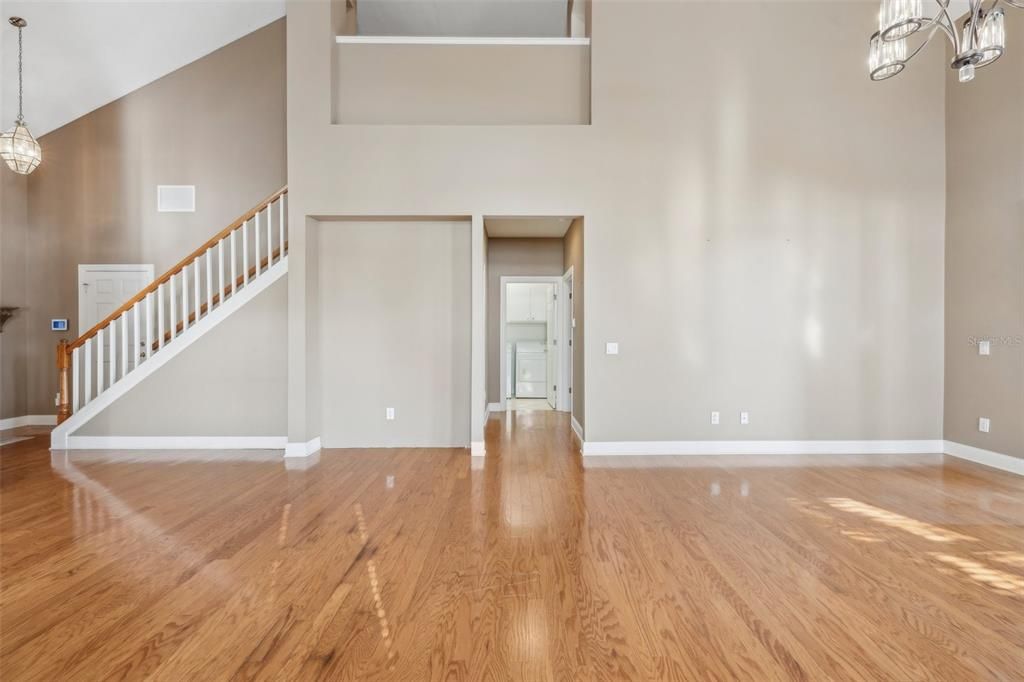 View from great room into 1/2 bath,  master BR, Mbath, and utility room; loft above