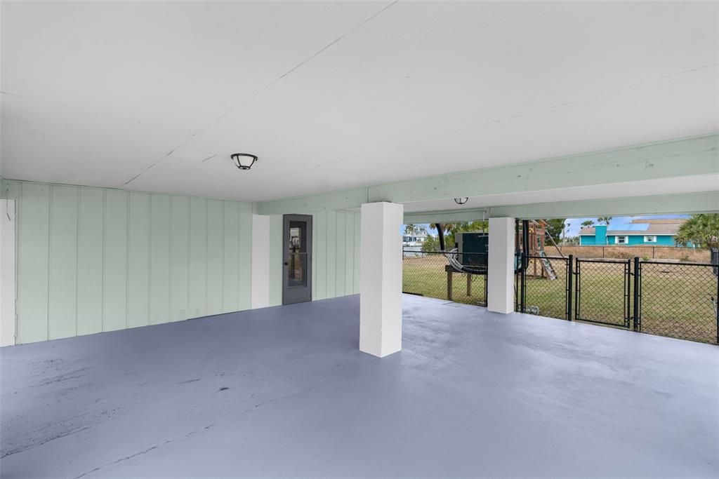 Carport area entrance to storage area/shed