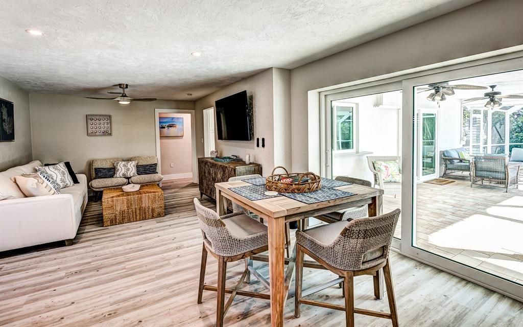 Open the glass sliding doors to allow the fresh Florida breezes to flow through. A pass through window with quartz bar top from the kitchen to the lanai makes entertaining a delight.