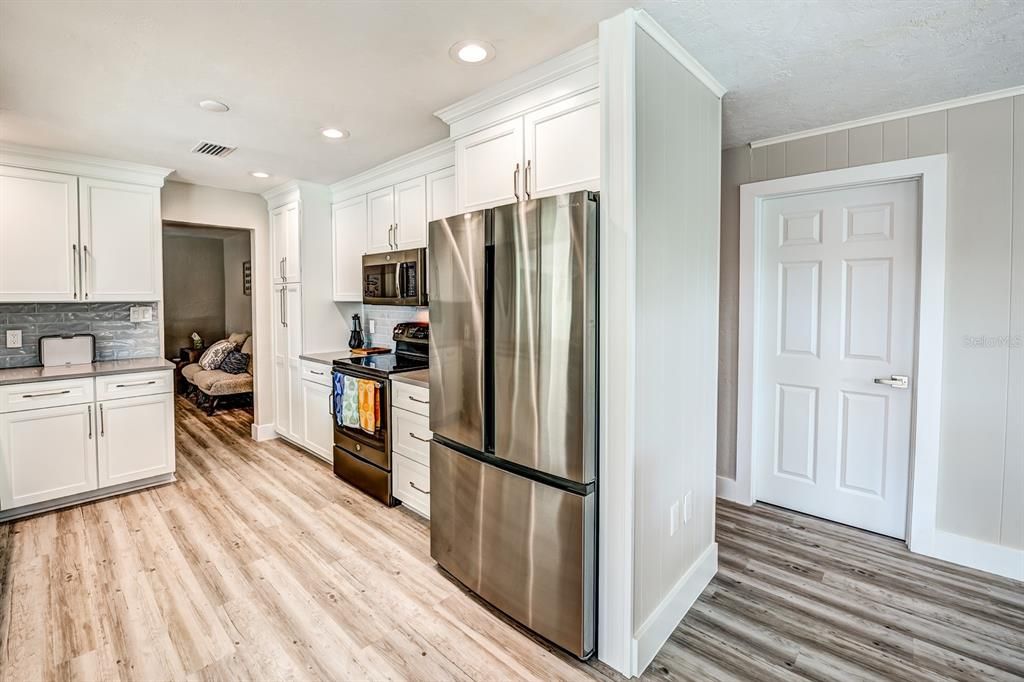 New recessed lighting has been installed in the kitchen. A spacious pantry adds even more storage.