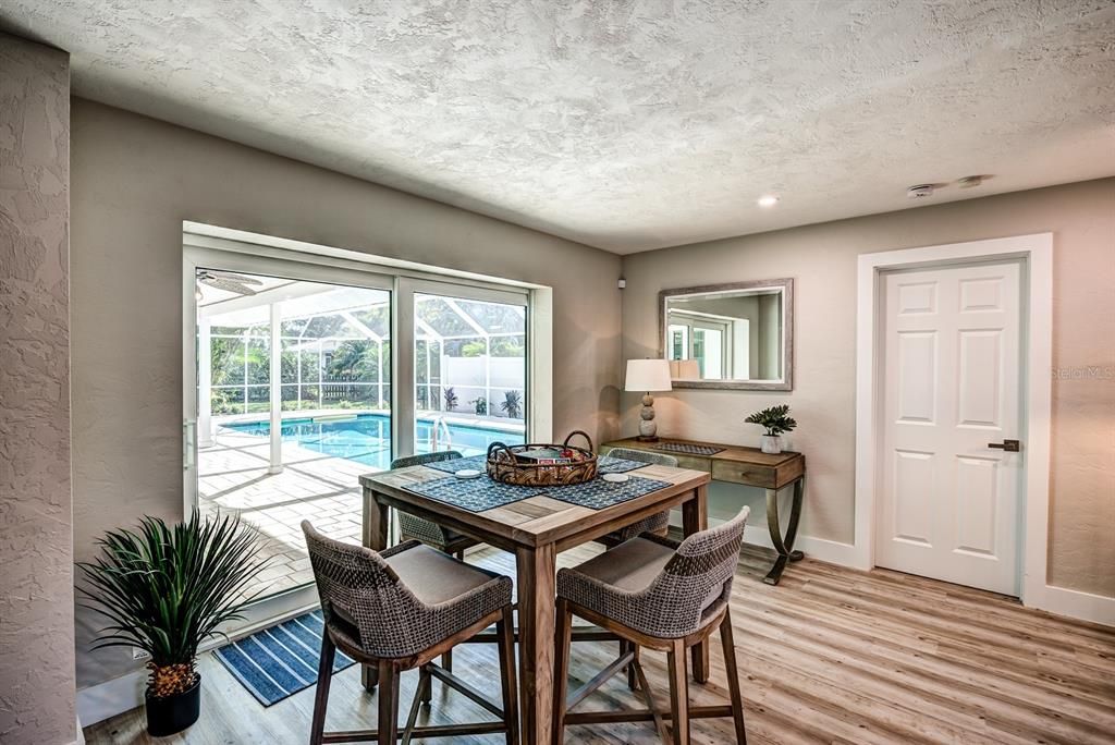 Fully pocketing glass sliding doors open from the great room to the lanai and pool area. The table can be moved outside to enjoy al fresco dining.