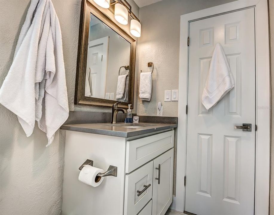 New cabinets with quartz countertops along with lighting and mirrors have been updated in both baths.