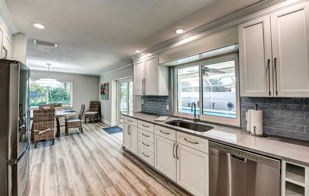 The chef of the family will love the updated kitchen complete with quartz countertops, designer tiled backsplashes and stainless appliances.