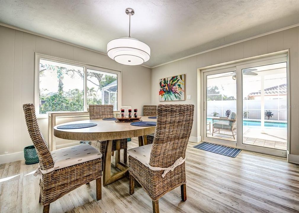 The light and bright dining room measures a robust 14x13 and has a fully pocketing glass sliding door to the lanai and pool area.