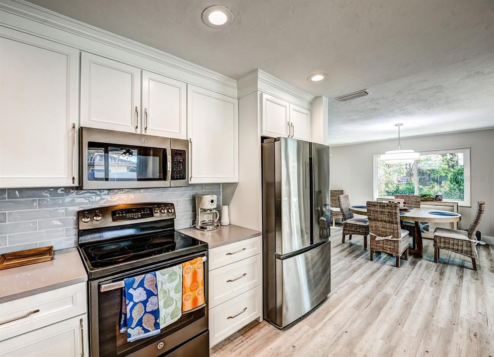 Loads of countertop prep space and tons of cabinet storage are found in the updated kitchen.