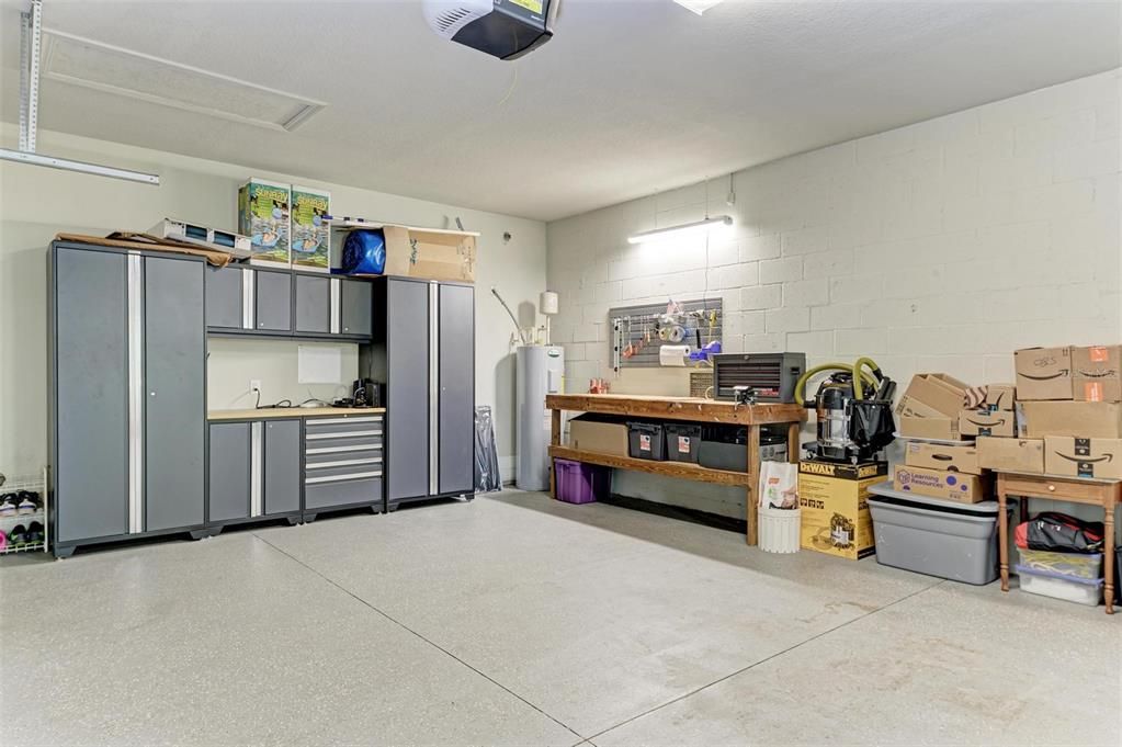 Oversized, 3-car garage with storage cabinets and EV charger.