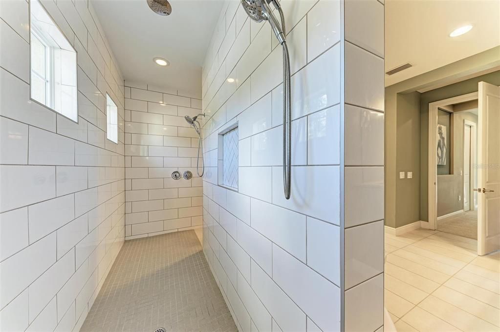 Huge walk-in shower with 2 shower heads plus a rain shower head.