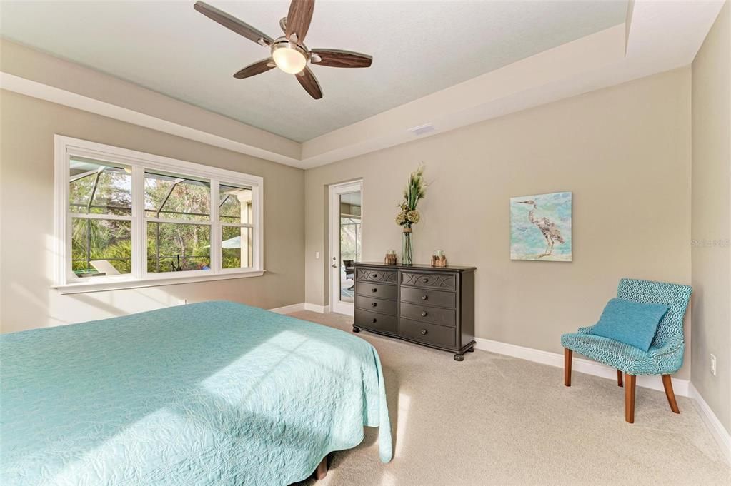 Primary bedroom with door leading to pool.