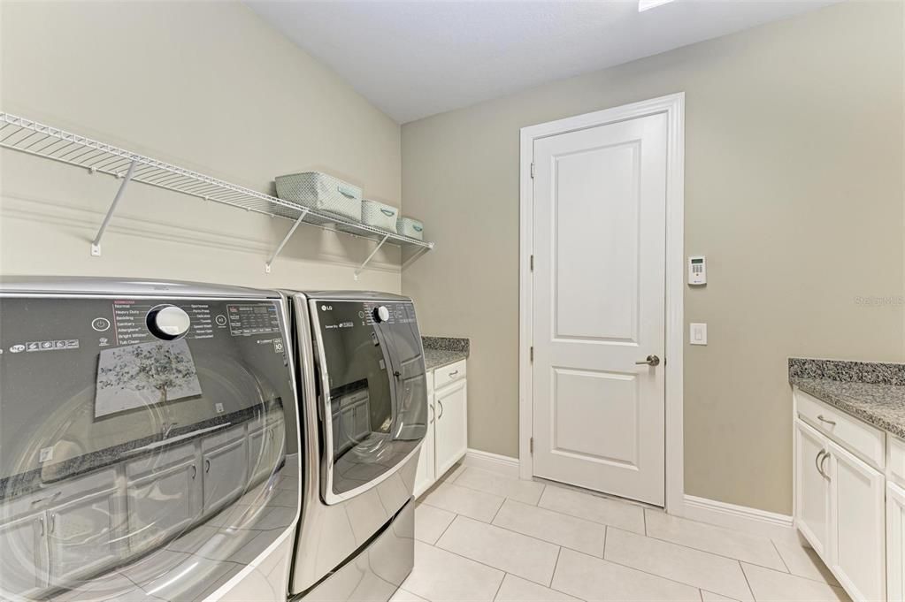 Large laundry room leading to garage.