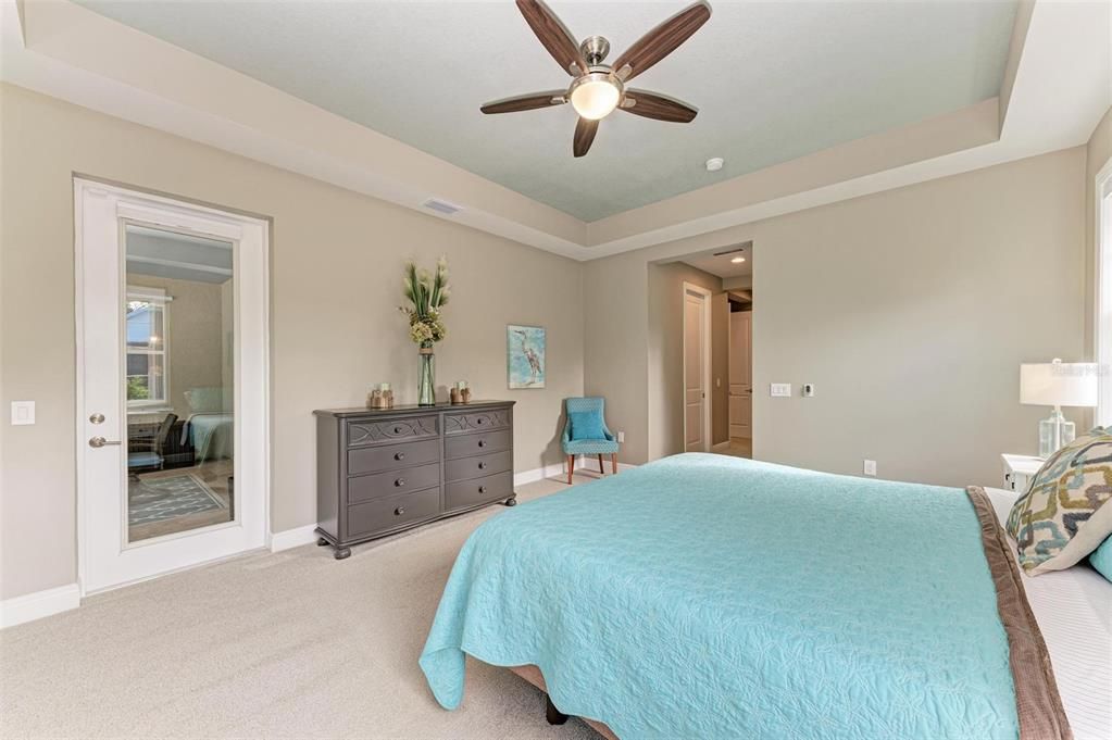 Primary bedroom with door leading to pool.